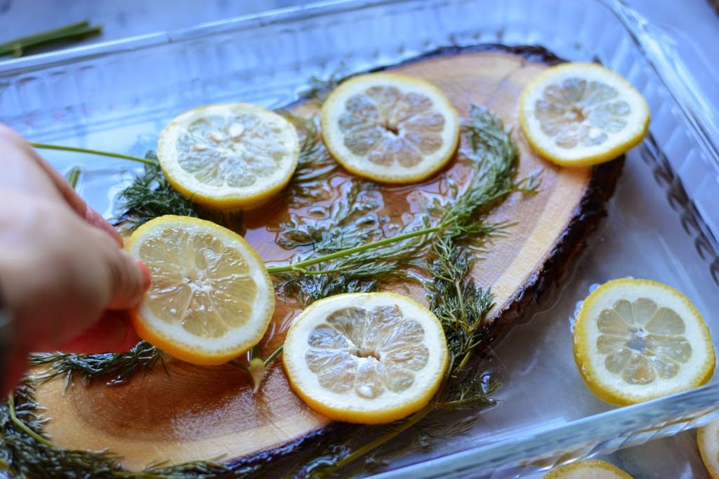 cedar plank in water with lemon and dill