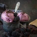 front view of Blackberry Chocolate Chip Ice cream in dark tin mug with blackberries, chopped chocolate