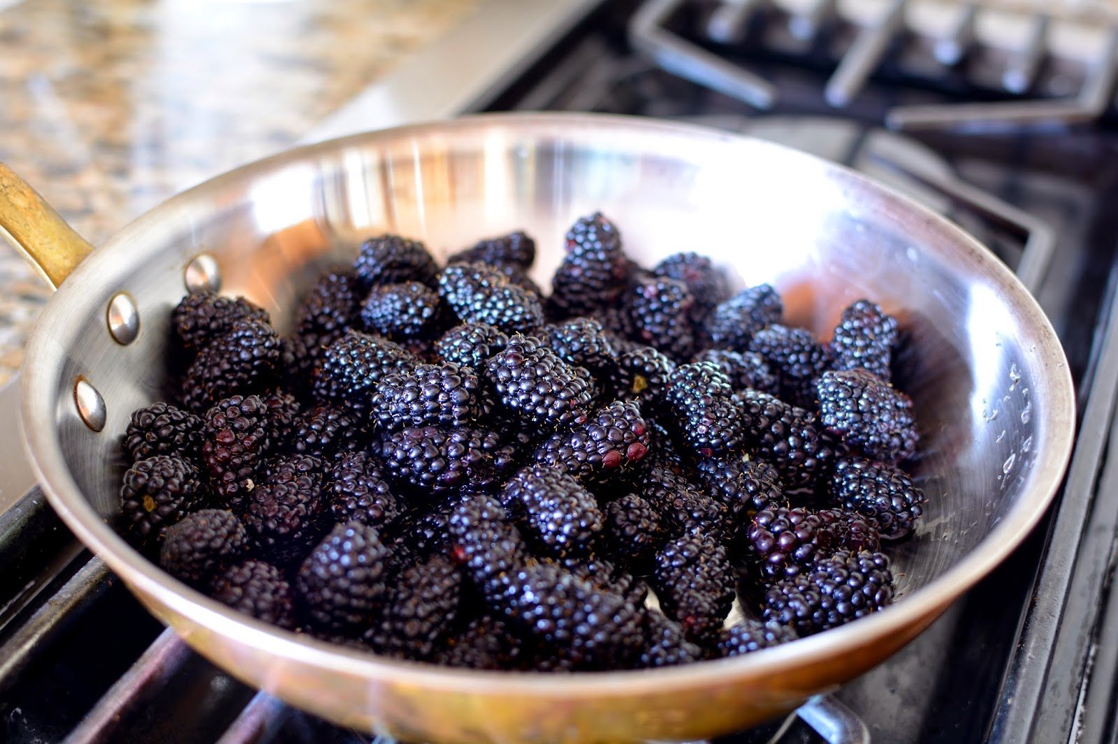 skillet filled with blackberries