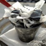 licorice caramels in a tin cup.