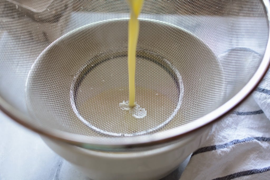 Vanilla ice cream custard poured through a wire mesh strainer.