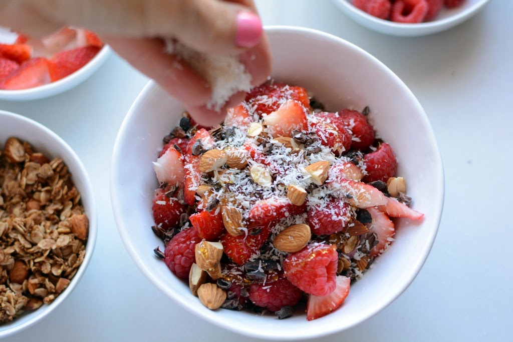 white bowl with acai smoothie topped with berries coconut added on top