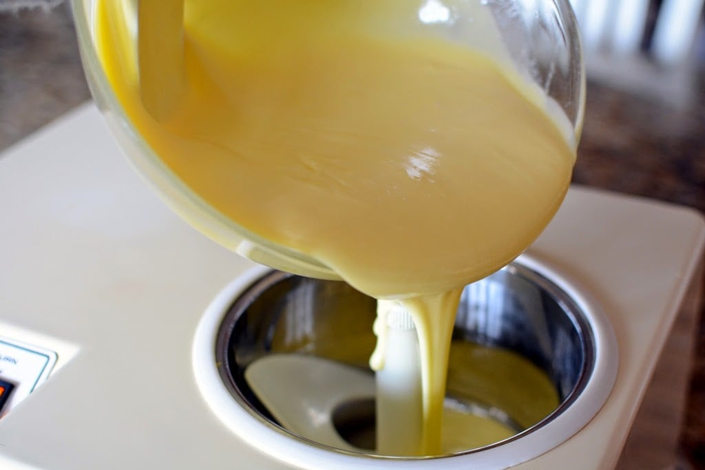 Golden vanilla ice cream pouring into ice cream maker