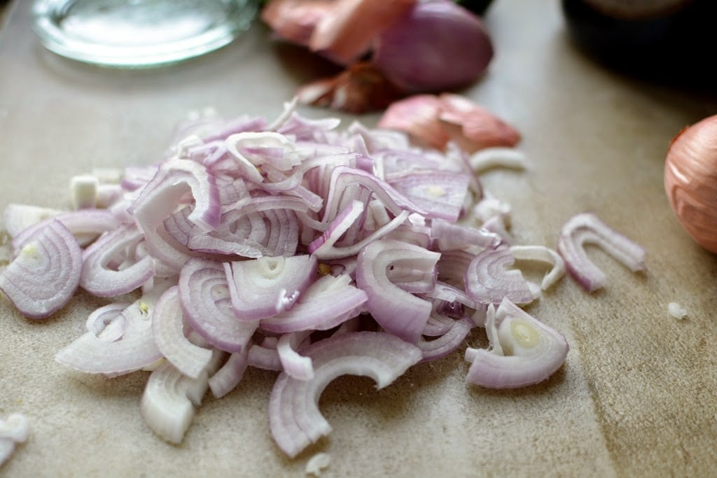 sliced shallots on cutting board