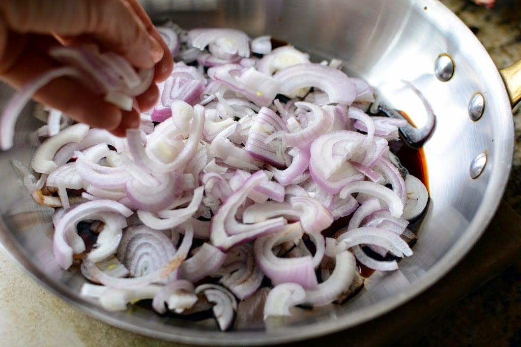 shallots in skillet with balsamic vinegar