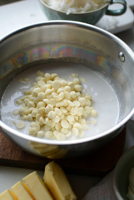 Saucepan with heated coconut milk and white chocolate chips.