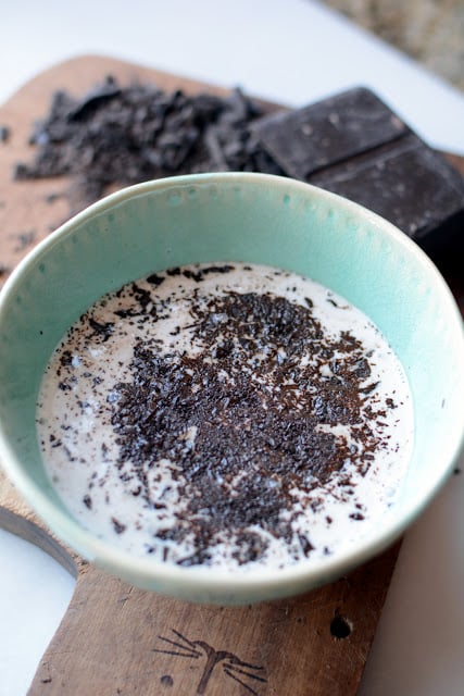 Bowl of chopped chocolate and hot milk.