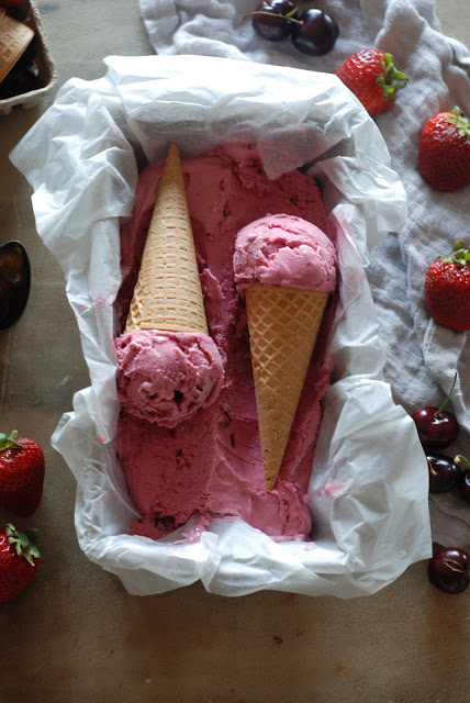 Two ice cream cones on top of ice cream