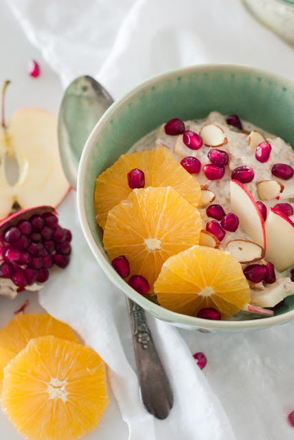 soaked oats with orange slices, pomegranates, and apples