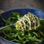 Avocado half stuffed with quinoa with cashew cream drizzle