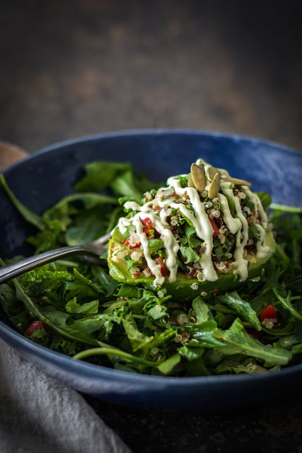 Avocado half stuffed with quinoa with cashew cream drizzle