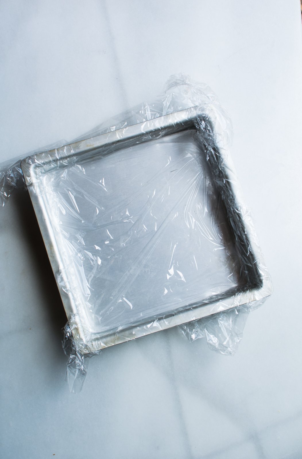 baking pan lined with plastic wrap