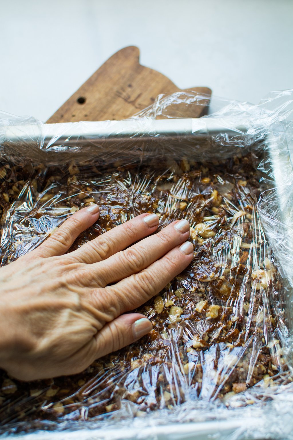 pressing nut bars into pan