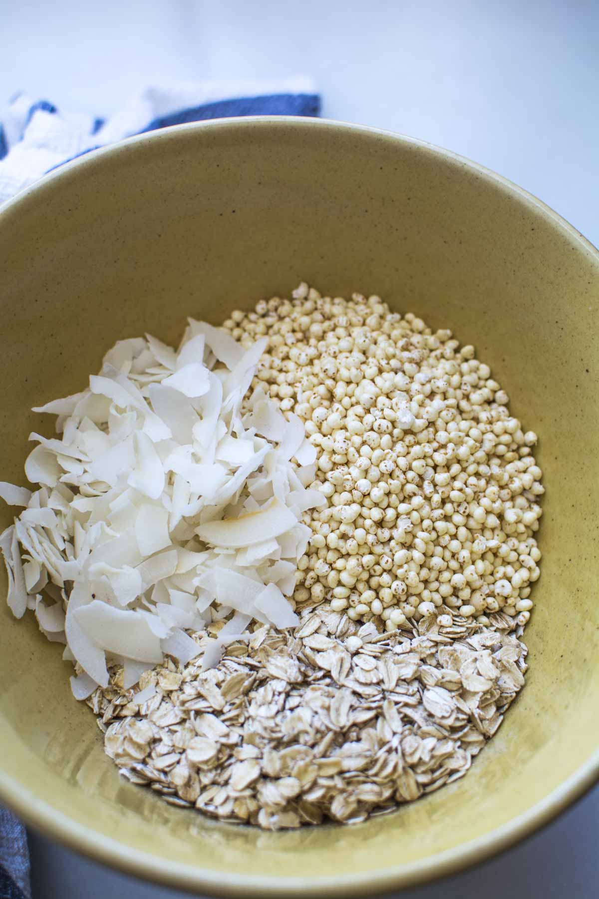 puffed millet, coconut, oats in a gold bowl