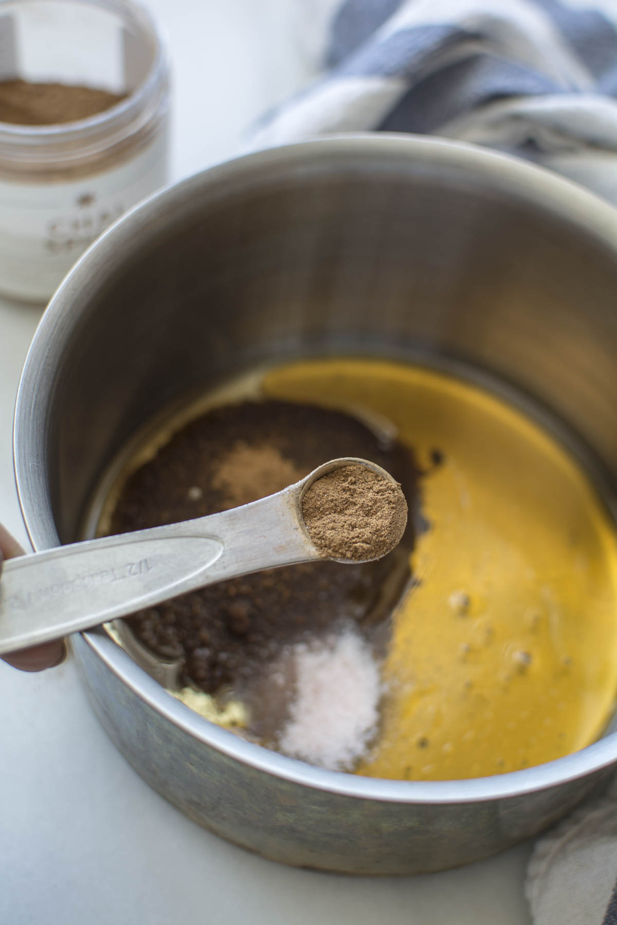 spices added to oil in saucepan