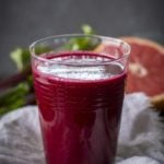 chia beet grapefruit juice in a glass with grapefruit in background