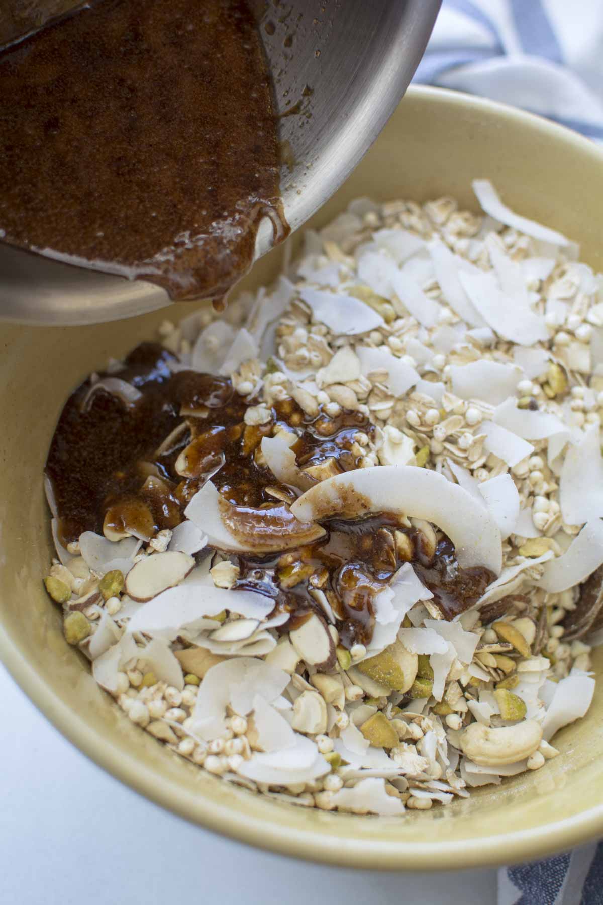 spice oil mixture pouring over oat nut mixture