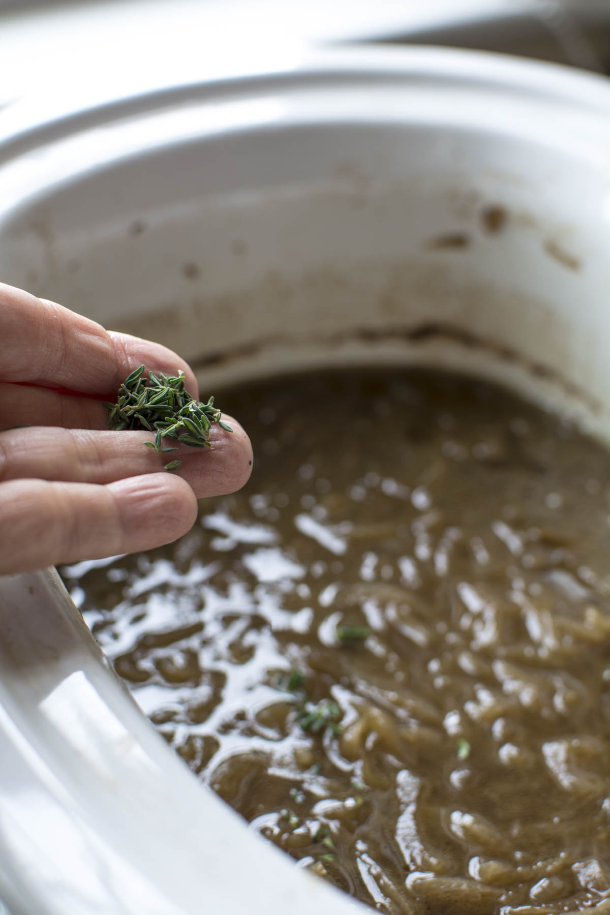 Adding fresh thyme and parsley to french onion soup