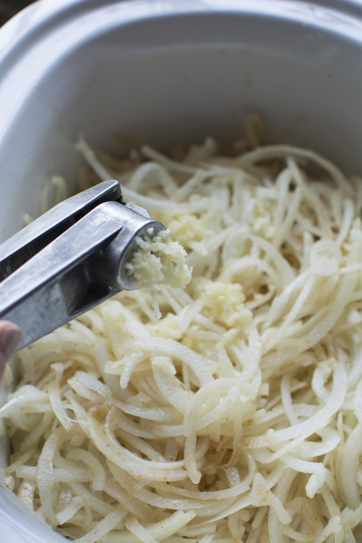 For french onion soup Sliced onions in a crockpot with a garlic press adding garlic