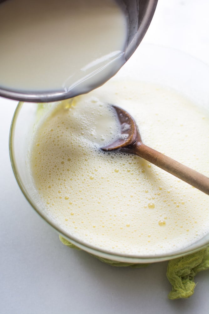 pouring hot milk into egg mixture