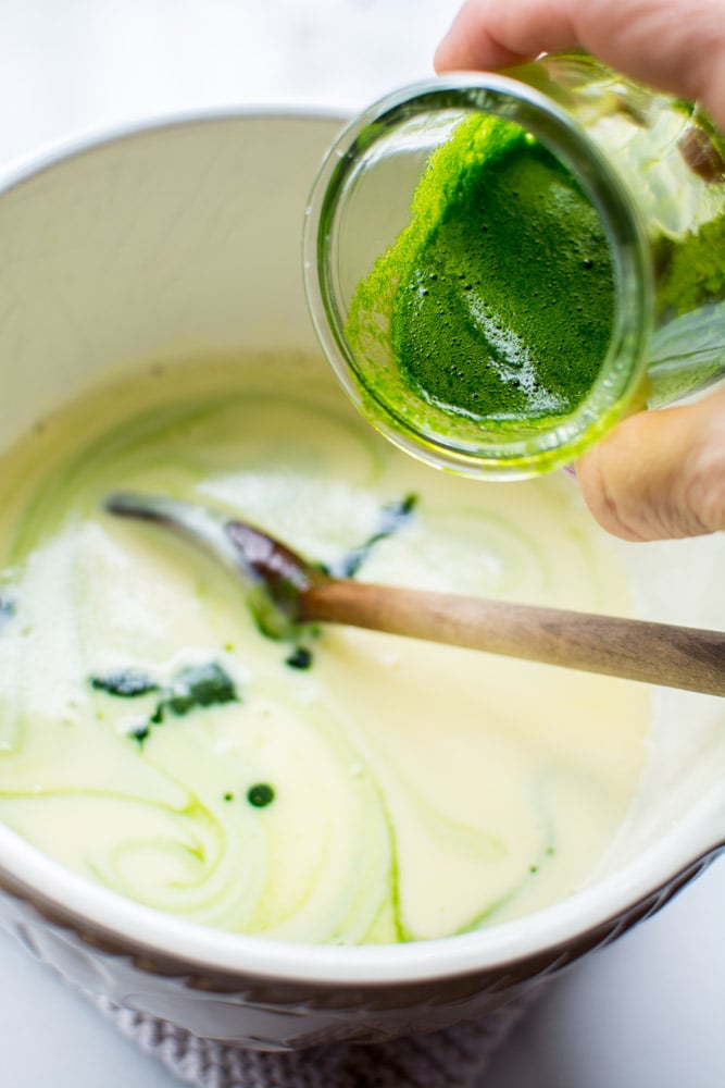 spinach juice pouring into custard
