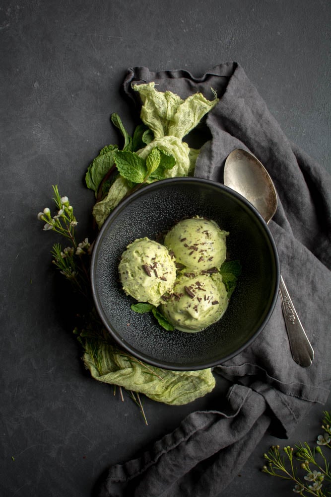 Spring Mint Chip Ice Cream in a black bowl with green cloth behind