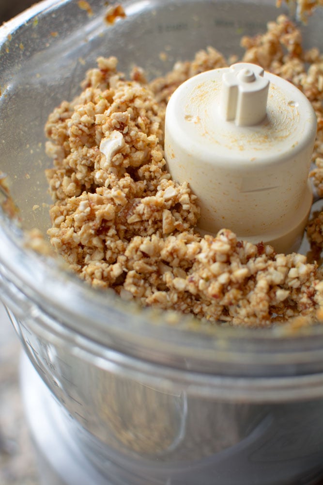 Food processor with chopped cashews, dates, and curry