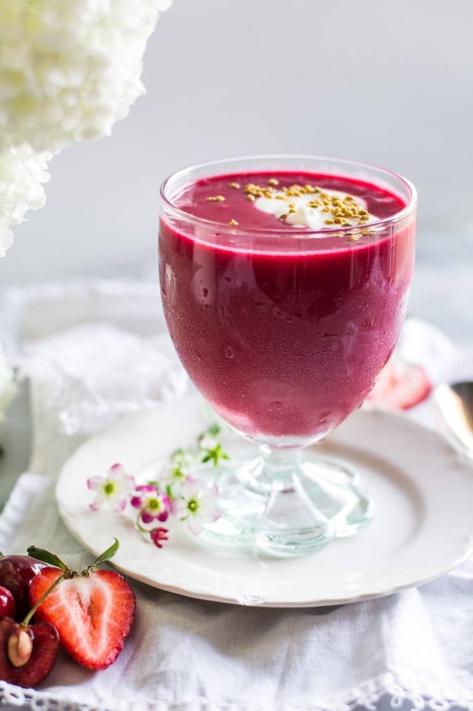 Berry Beet Smoothie in a glass on a white plate