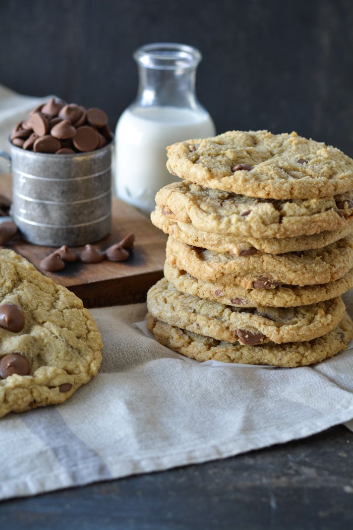 Jumbo size chocolate chip cookies stacked with bottle of milk