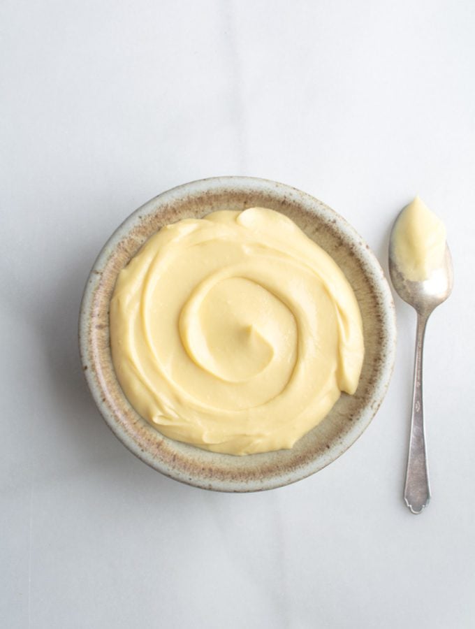 Velvety Vanilla pastry cream in a bowl with a spoon
