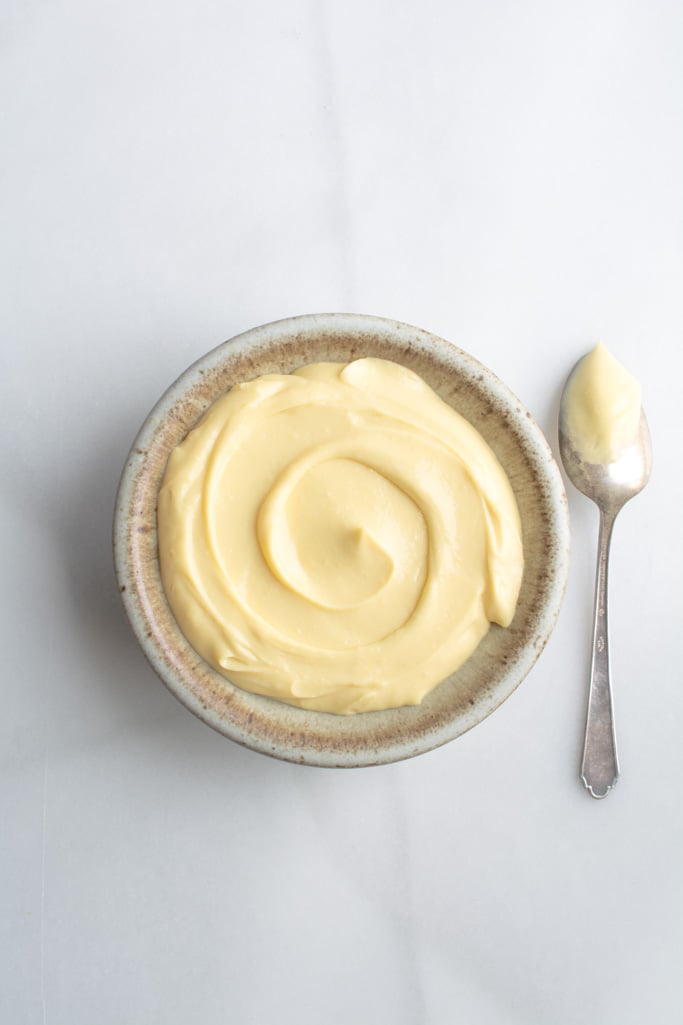 Velvety Vanilla pastry cream in a bowl with a spoon