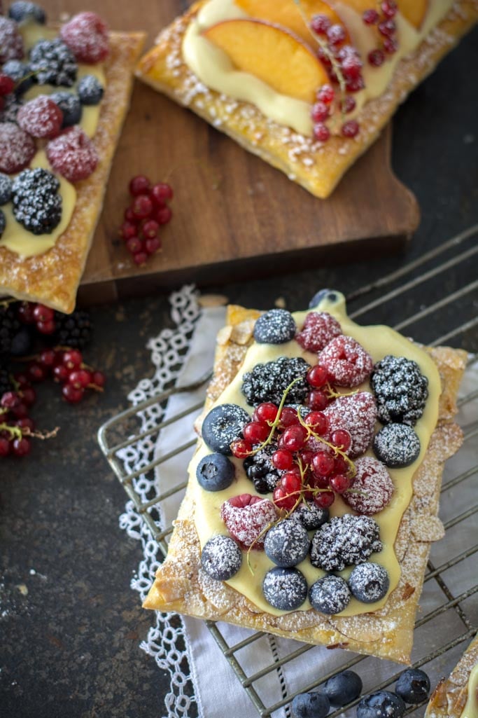 Easy Fresh Berry Puff Pastry Tarts on a cooling rack with white cloth