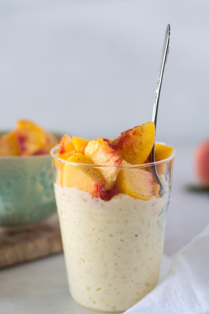 Simple Rice Pudding and Peaches glass cup with rice pudding peaches on top