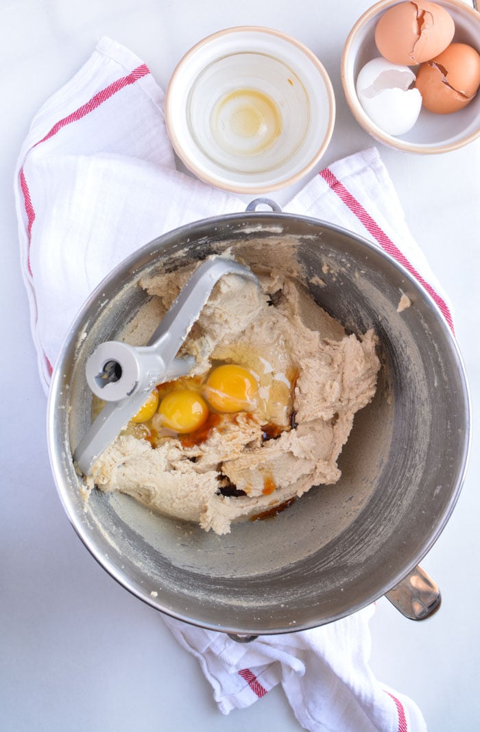 Eggs being mixing into batter for jumbo chocolate chip cookies