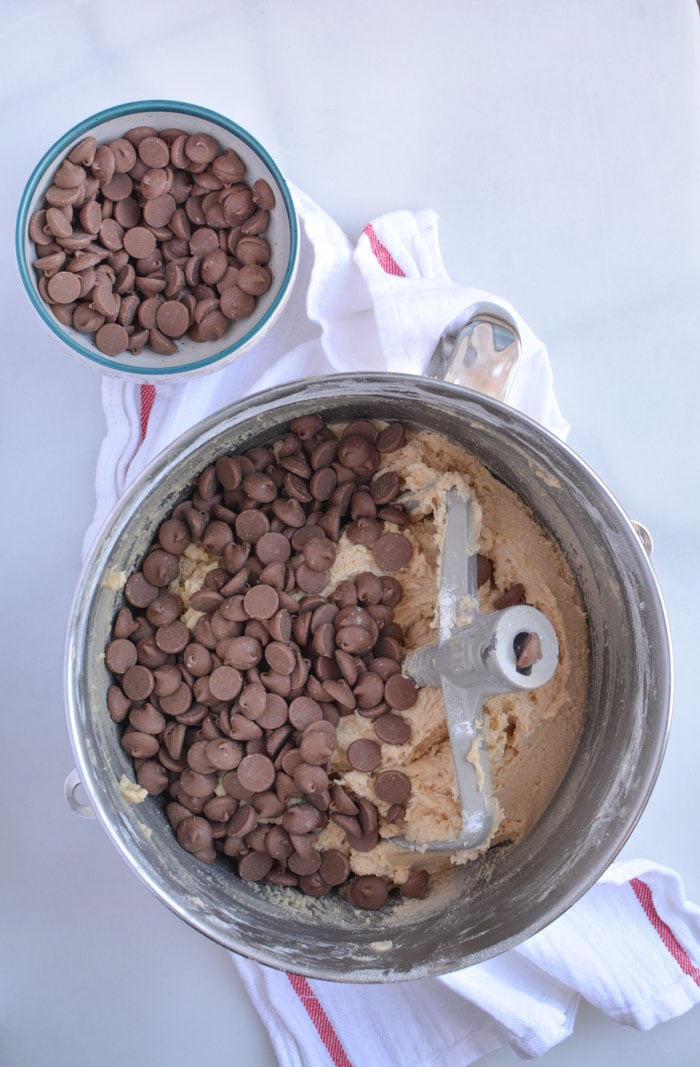 Chocolate Chips being added to batter for jumbo chocolate chip cookies dough