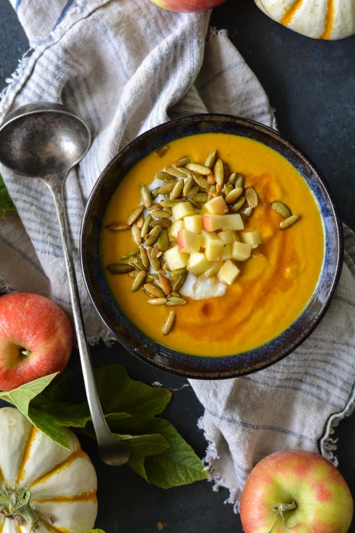 Pumpkin Apple Soup in bowl with ladle 