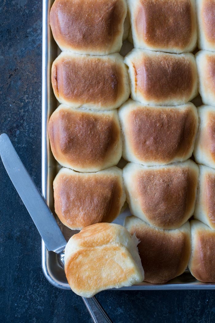 Buttery Parker House Rolls baked on baking sheet