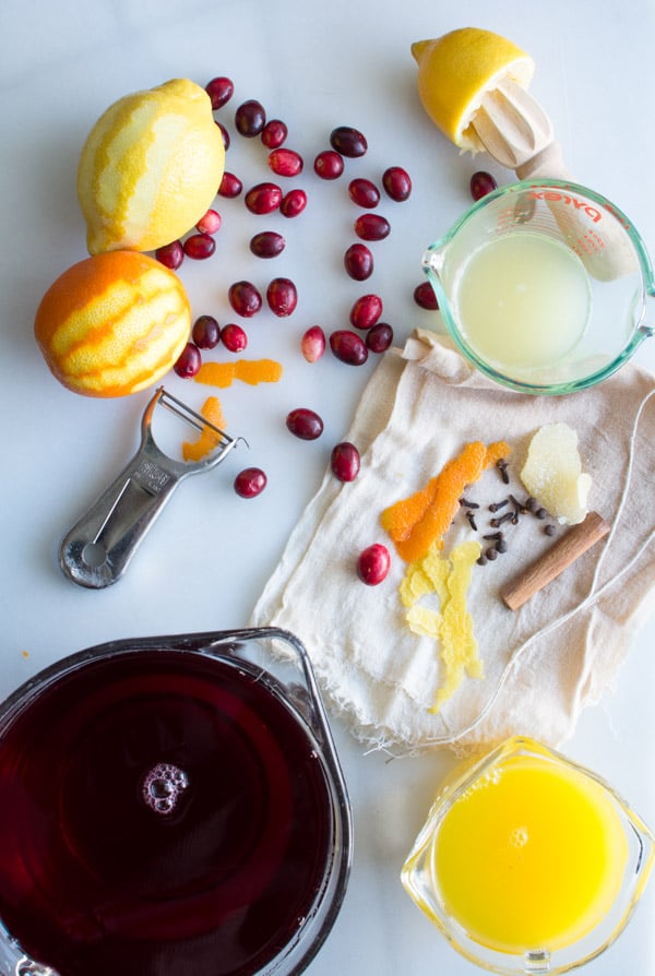 cranberries scattered with oranges, lemons on a marble slab