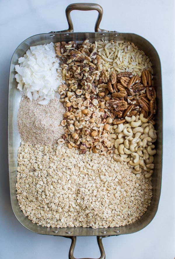 oats, nuts, coconut in baking pan