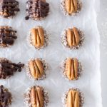 Date bites with whole pecans on parchment