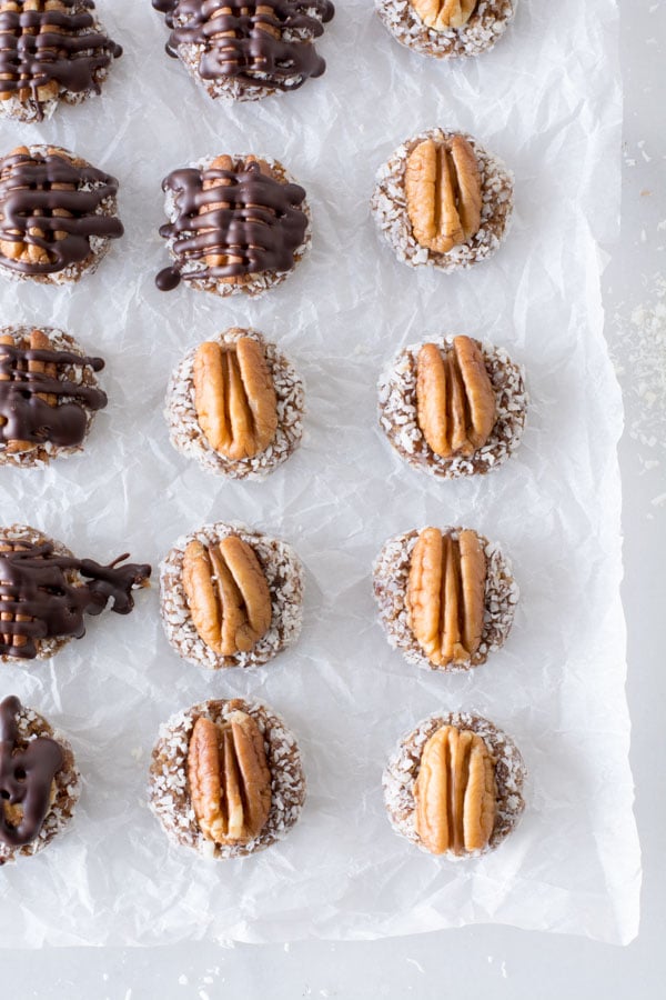 Date bites with whole pecans on parchment