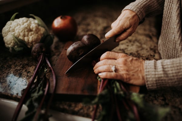 Cutting beets on wooden board