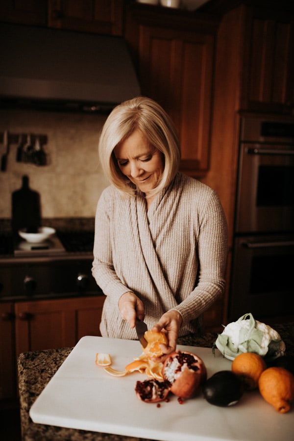 Janet cutting an orange and other fruits