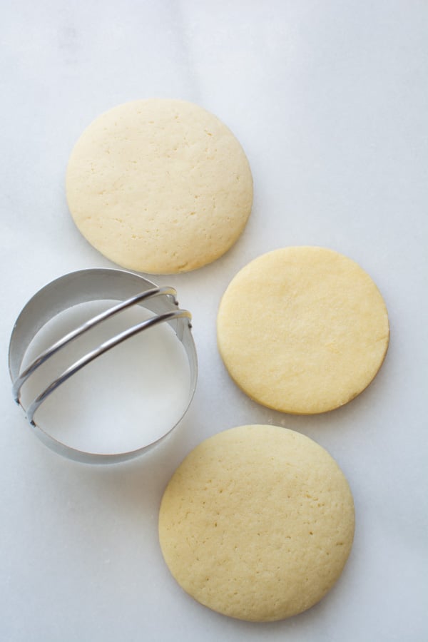 three round sugar cookies with cutter