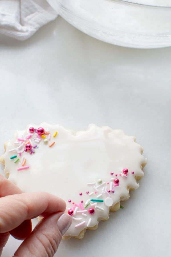 iced heart shaped cookie with sprinkles