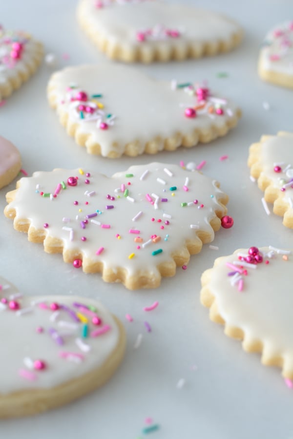 angle view of iced heart shaped sugar cookies with sprinkles