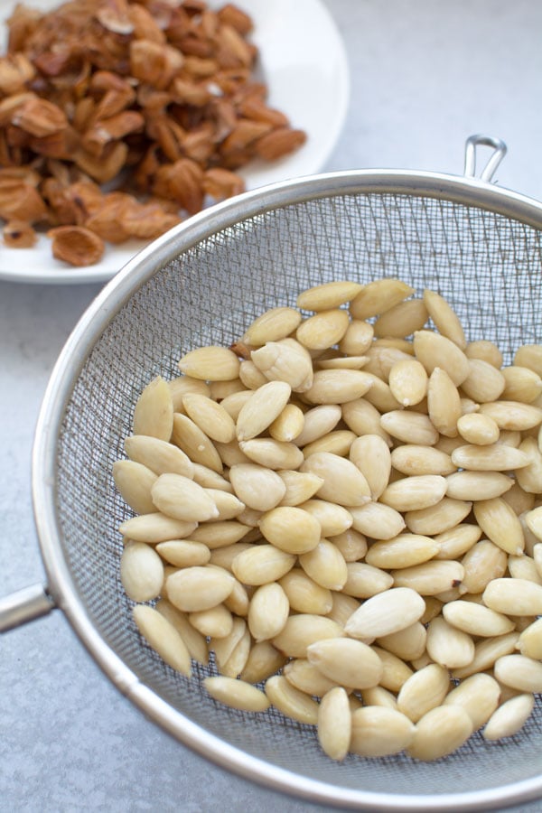 Blanched almonds in strainer