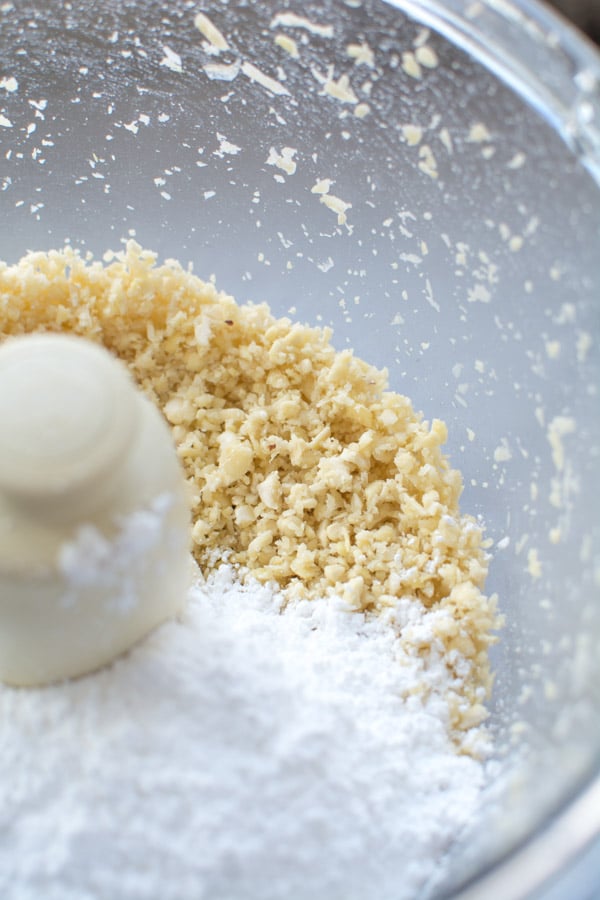 Blanched almonds and powdered sugar in food processor