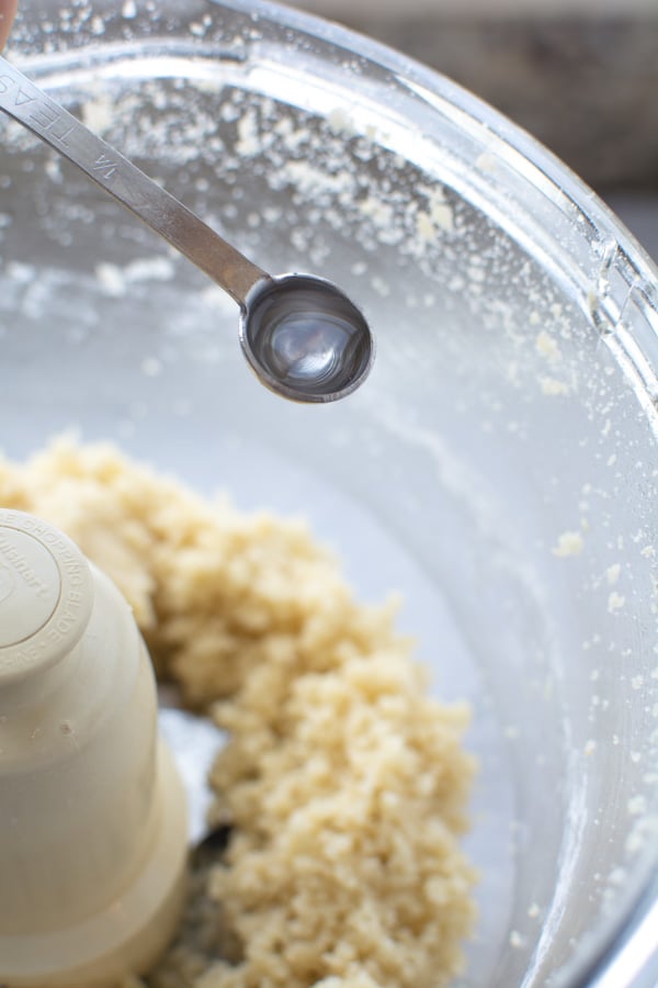 ground marzipan with spoonful of almond extract