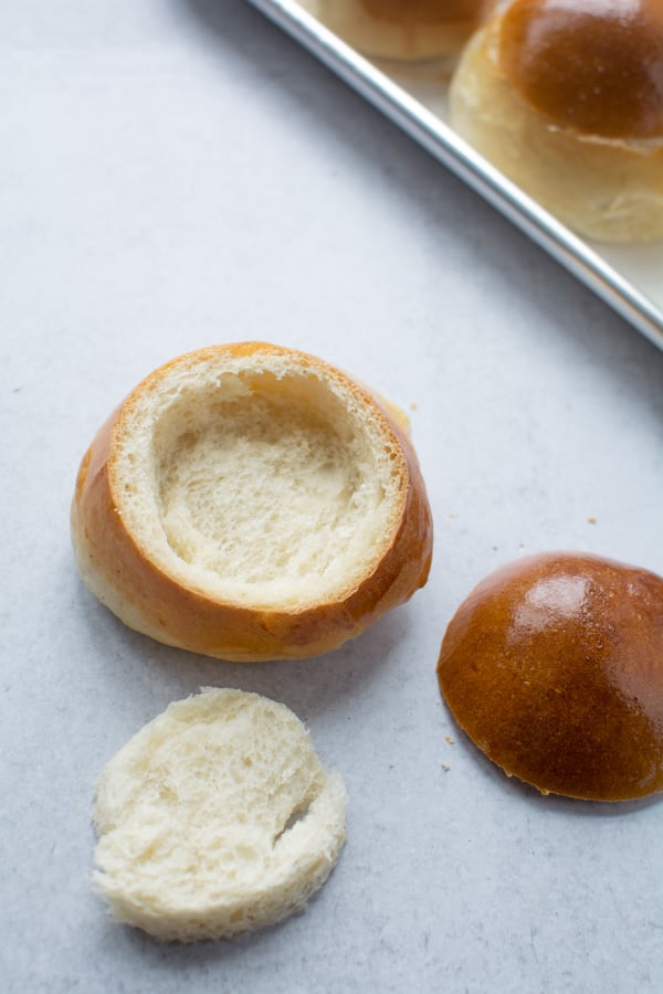Hollowed out Semlor bun, with top and inner section of bread set to the side.